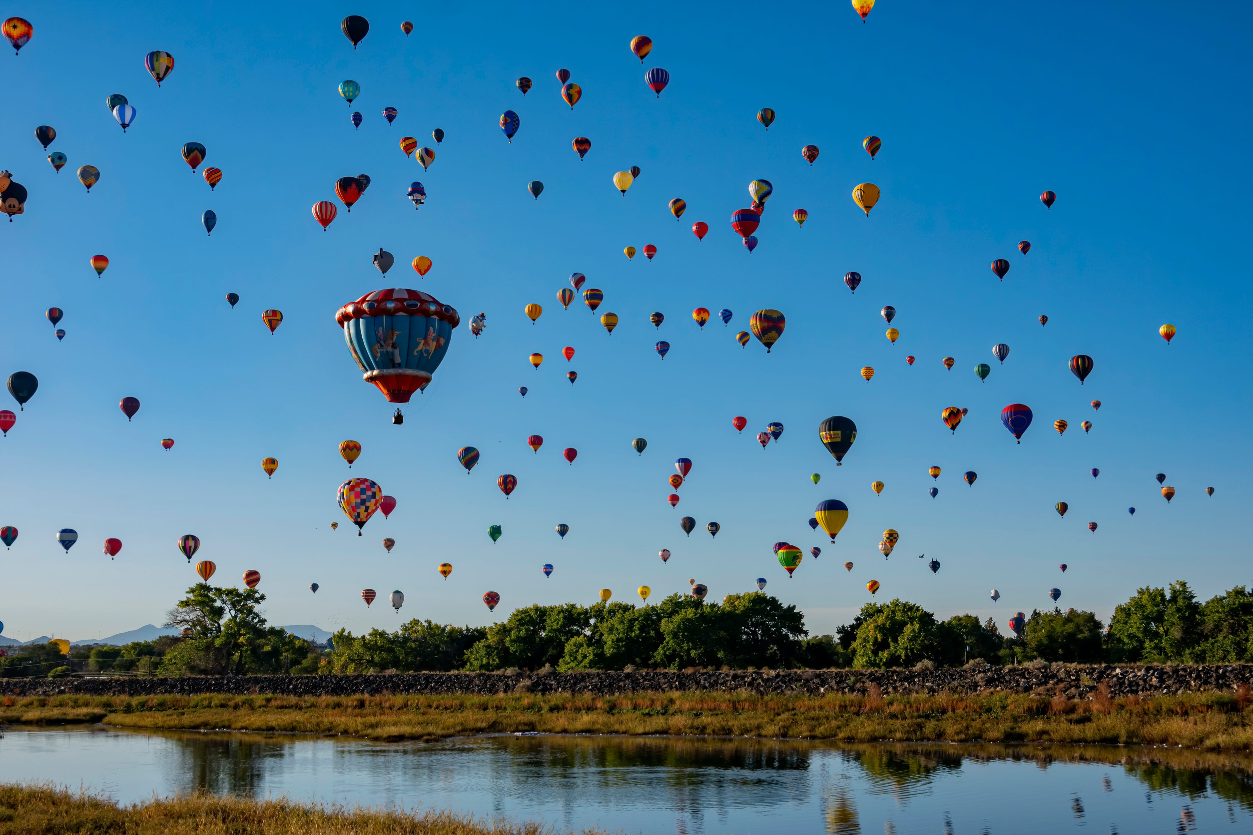 Hot air balloons over lake