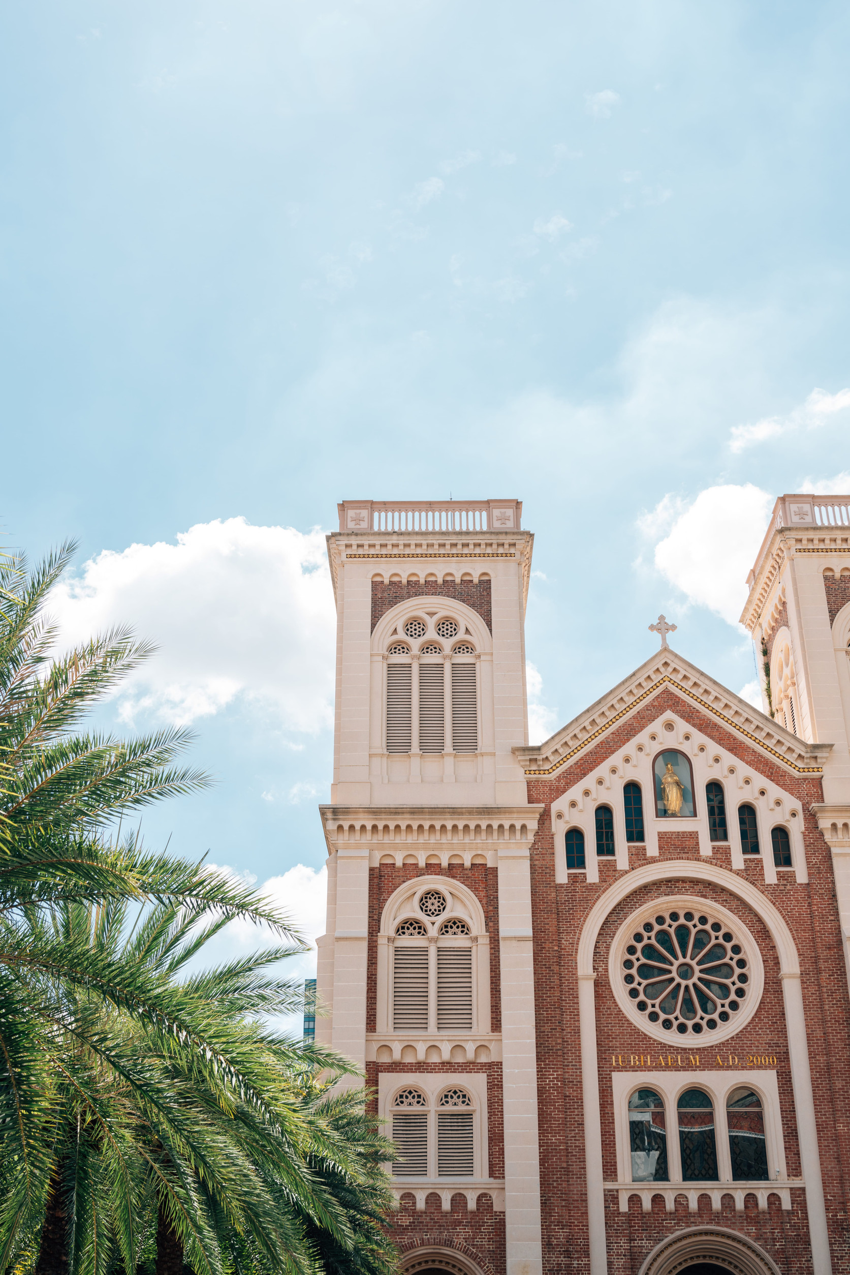 palm trees and brick church building