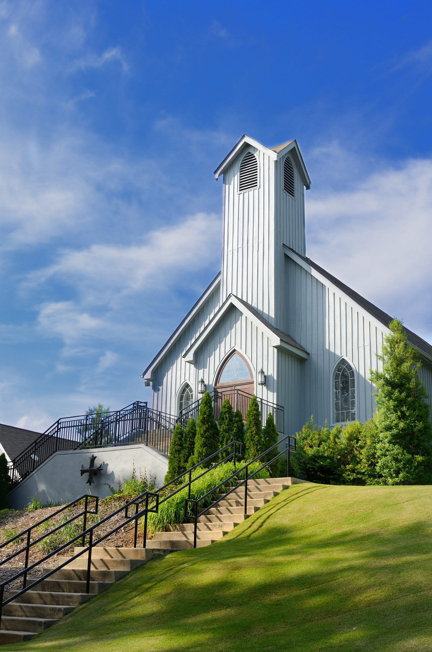 white church on a hill with stairs