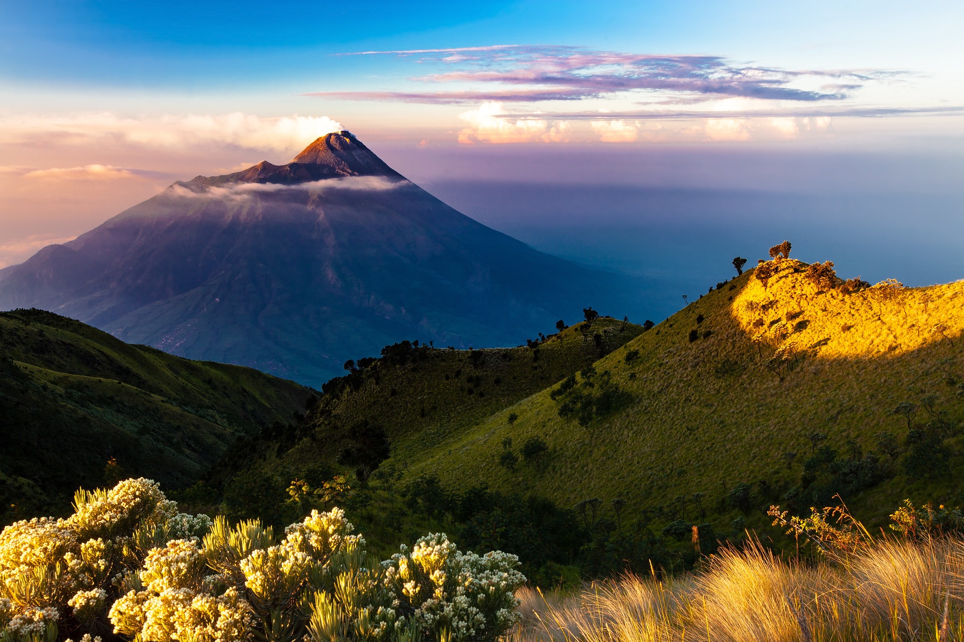 Mountain peak with clouds and landscape.